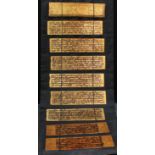 A set of nine Tibetan prayer tablets, each panel inscribed in calligraphy on a gilt ground, each