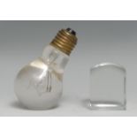 An early to mid-20th century novelty glass desk weight, as a light bulb, 9cm high; a domed square