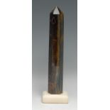 A tiger's eye desk obelisk, 26.5cm high