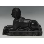 A 19th century matt black pressed glass model of a sphinx, by Molineaux Webb, 21cm wide,