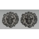 A pair of 19th century lead bosses, as lion masks, 8cm long