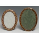 An early 20th century tooled and gilt leather oval easel photograph frame, retailed by Walter Jones,