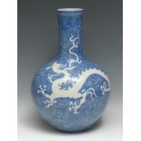 A large Chinese porcelain bottle vase, incised with a ferocious dragon pursuing a pearl on a