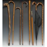Walking Sticks - a 19th century Indian silver mounted walking cane, the tall pommel chased with