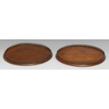 A pair of 19th century mahogany circular gallery trays, pierced brass borders, 26cm diam