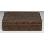 An Indian hardwood rectangular box, profusely carved with scrolling leafy stems, hinged cover