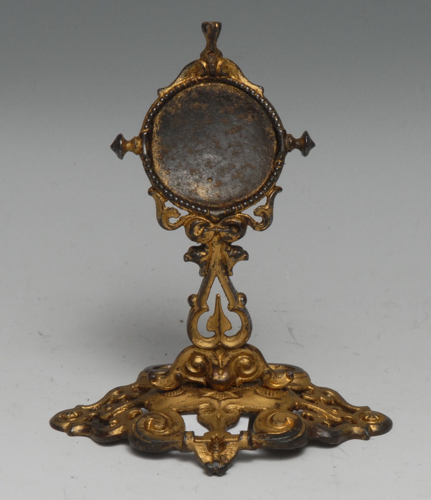 A 19th century gilt metal pocket watch stand, cast throughout with scrolls and strapwork, 13cm high,