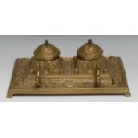 A 19th century French gilt-brass rectangular inkstand, centred by a pair of inkwells cast as profus