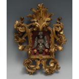 An 18th century Continental giltwood cartouche shaped frame, enclosing a momento mori tableau,