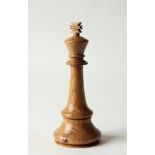 An Over-sized King Chess Piece, turned from Oak, as a desk curiosity, 22cm tall.