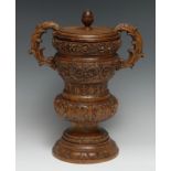 A large 19th century oak tobacco jar and cover, of country house proportions, boldly carved