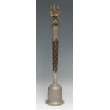 A Tibetan Buddhist temple bell, phurba finial, studded hardwood haft, 40cm long