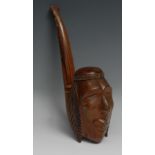 An unusual hardwood oversize pipe, the bowl carved as the head of a Native American, 33cm long