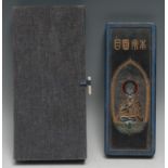 A Chinese scholar's ink stone, in relief and picked out in polychrome with Buddha and