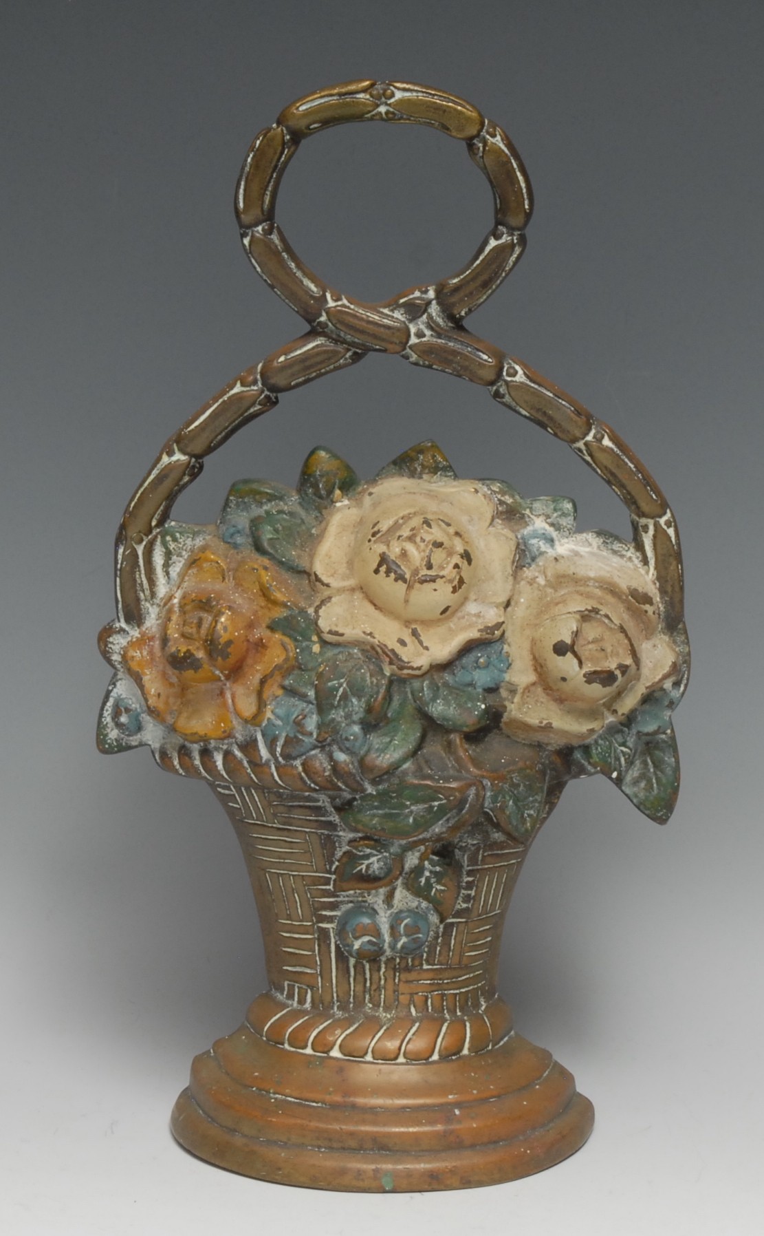 A 19th century brass door stop, cast as a basket of flowers, decorated in polychrome, 31.5cm high