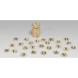 A 19th century bone child's teaching spelling alphabet, the circular counters contained within a