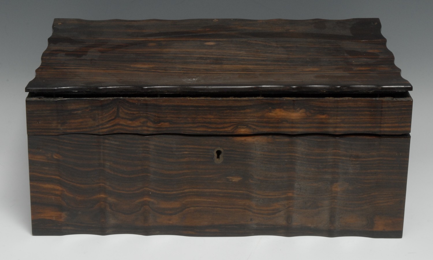 A 19th century Anglo-Indian/Ceylonese commode shaped work box, hinged cover enclosing a marquetry