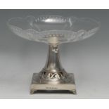 A WMF Art Nouveau period comport, clear glass plateau, square base pierced and embossed with a