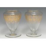 A pair of 19th century clear glass inverted ovoid jars, each gilded with a band of trellis and