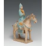 A Chinese terracotta equestrian figure, of an official on horseback, modelled in the Tang manner,