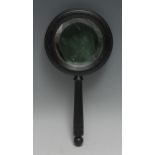 An early 20th century ebonised hand mirror, bevelled plate, turned handle, 25.5cm long