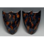 A pair of Denby stoneware shield-shaped wall pockets, glazed in mottled tones of blue and brown,