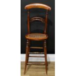 A Victorian beech child's correction high chair, curved cresting rail, pierced bar back, oval cane