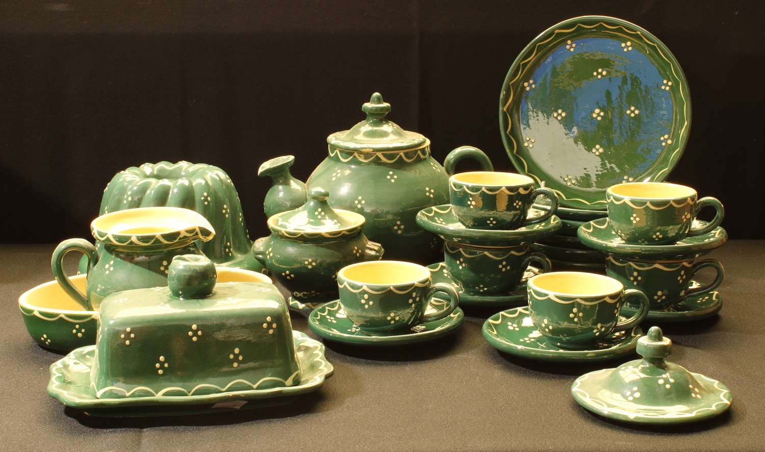 A Soufflenheim pottery tea and breakfast set, in green with white polka dots, teapot, butter dish,