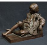 After Tharel, a bronze statue of a young boy reclining with a violin by his side, signed 'Tharel