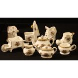 A Coalport miniature teapot, milk jug and sugar bowl, 5cm high; other Coalport miniatures,