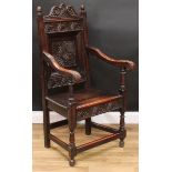 A 19th century oak Wainscot armchair, shaped cresting carved with flowerhead bosses, flanked by