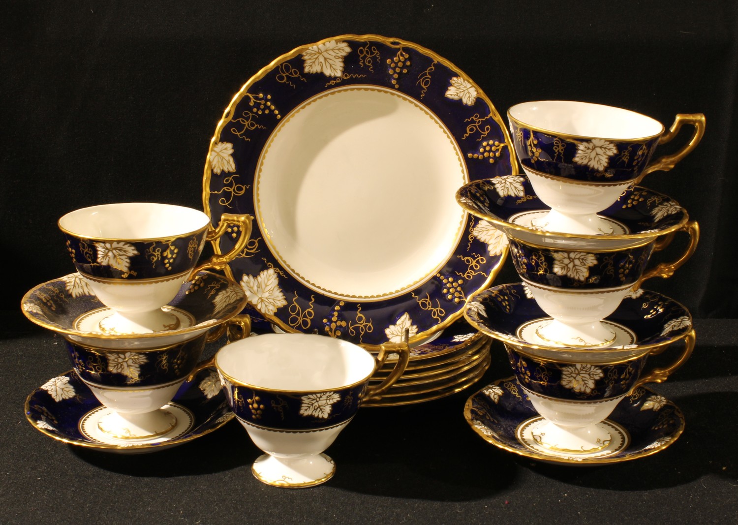 A Royal Crown Derby Vine Cobalt pattern tea set, six cups, five saucers, six tea plates, sandwich