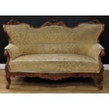 A Louis XV style sofa, carved and applied in the French Rococo taste, stuffed-over upholstery,