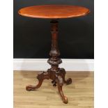 A Victorian walnut and mahogany tripod wine table, moulded oval top, turned column carved with