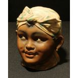 Black Americana - a Continental bisque tobacco jar modelled as a woman's head, 12cm high