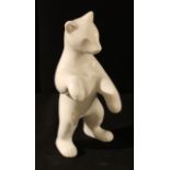 A Russian porcelain model of a bear, standing on his rear legs, glazed in white, 19.5cm, printed