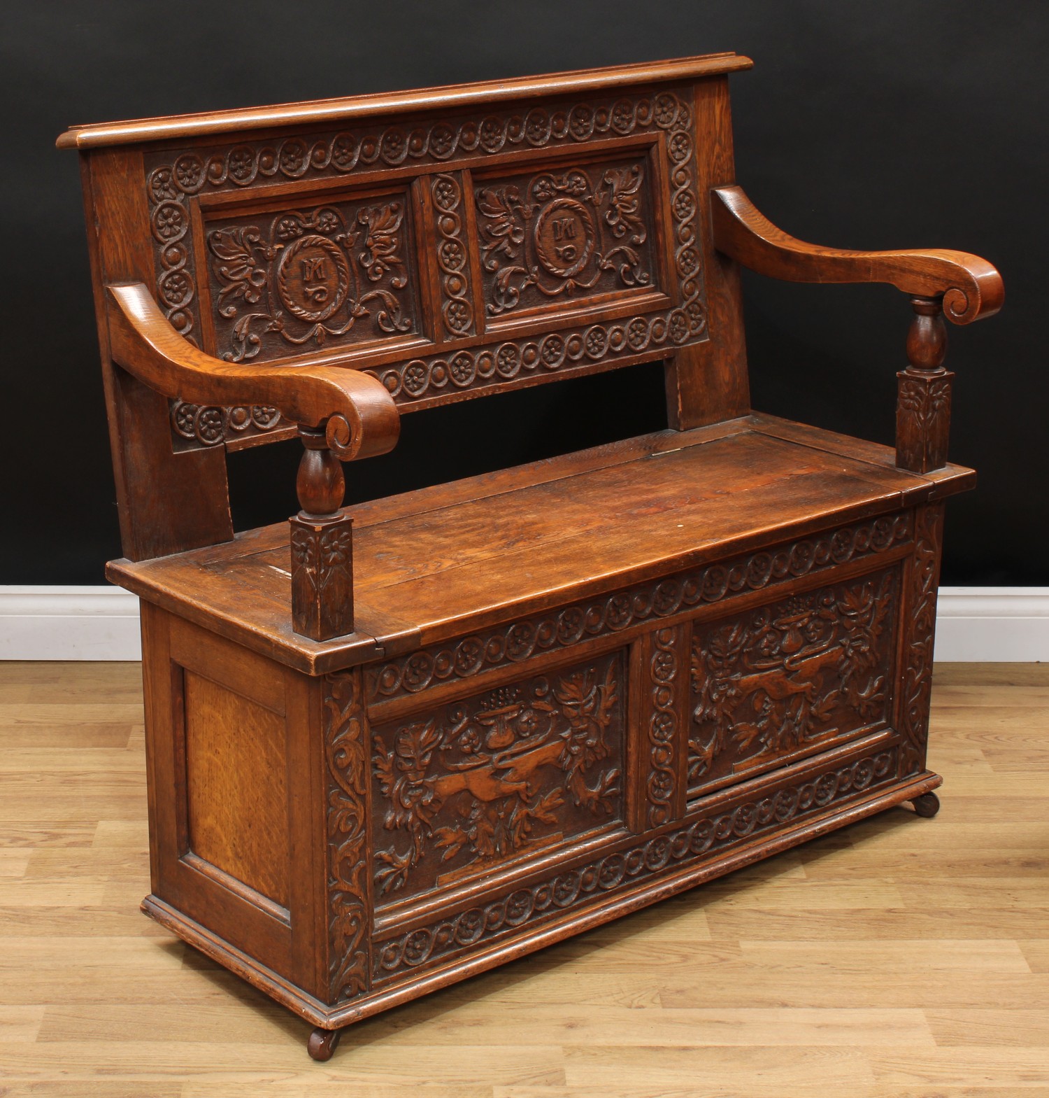 A 17th century style oak box settle or bench, two panel rectangular back initialled MA and carved - Image 2 of 3