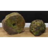 A millstone, 50cm 'diameter', 18cm deep; a partially honeycomb weathered stone, 34cm high, 37cm