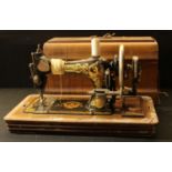 A hand cranked sewing machine, by Frister & Rossmann