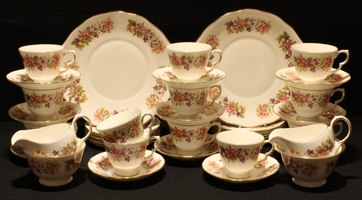 A Colclough Honeysuckle pattern tea set, twelve cups, eleven saucers, twelve tea plates, two sugar