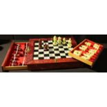 A Chinese style chess set and folding storage board, cast resin pieces, the case carved and