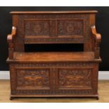 A 17th century style oak box settle or bench, two panel rectangular back initialled MA and carved