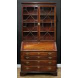 A 'George III' mahogany bureau bookcase, of composed form, outswept cornice above a pair of glazed