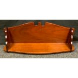 A mahogany wall hanging shelf, swan neck crest, waterfall supports, bowed front, 84cm wide, 31cm