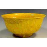 A Contemporary Chinese yellow monochrome bowl, relief decorated with dragons amongst clouds, six