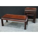 A Chinese style hardwood nest of three occasional tables, rectangular panel tops, manufacturers