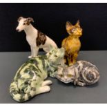 A Winstanley pottery cat, 37cm long; others, dogs etc (4).