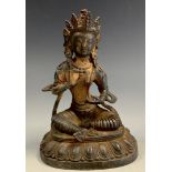 A contemporary bronzed metal figure as a seated goddess, possibly Tibetan, 20cm high.