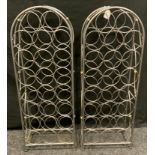 A pair of arched metal wine racks, each to hold 25 bottles, 86cm x 32cm x 17cm