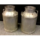 A pair of 20th century milk churns.